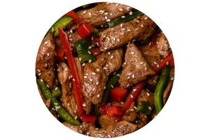 Delicious Asian teriyaki meat with red and green bell peppers photo