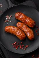 Delicious grilled chicken or pork sausages with salt, spices and herbs photo