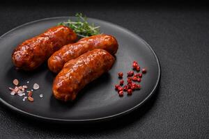 Delicious grilled chicken or pork sausages with salt, spices and herbs photo