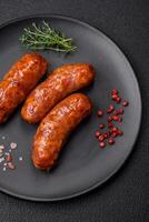 Delicious grilled chicken or pork sausages with salt, spices and herbs photo