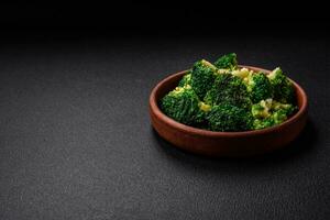 Delicious fresh green broccoli steamed in a ceramic plate photo