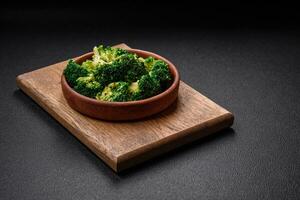 Delicious fresh green broccoli steamed in a ceramic plate photo