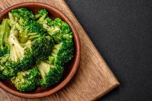 Delicious fresh green broccoli steamed in a ceramic plate photo