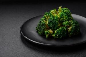 Delicious fresh green broccoli steamed in a ceramic plate photo