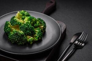 Delicious fresh green broccoli steamed in a ceramic plate photo