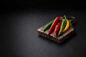 Hot chili peppers of three different colors red, green and yellow photo