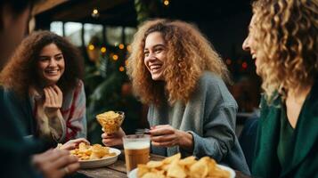 Group of friends enjoying drinks and snacks photo