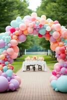 Colorful balloon arches over dessert table photo