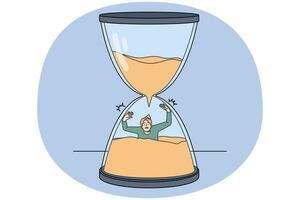 Stressed man sinking in hourglass photo