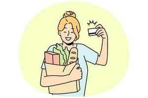 Smiling woman grocery shopping with credit card photo