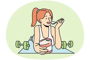 Smiling woman lying on fitness mat eating ice cream photo