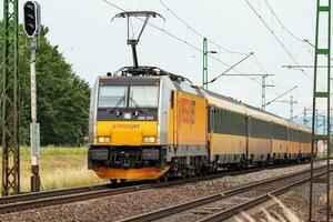 Regiojet Bombardier Traxx. International and regional railway transportation. Passenger freight train set at station. Public transport. photo