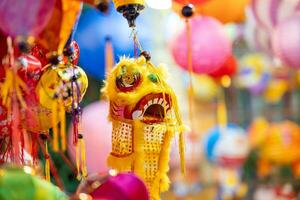 Decorated colorful lanterns hanging on a stand in the streets in Ho Chi Minh City, Vietnam during Mid Autumn Festival. Chinese language in photos mean money and happiness. Selective focus.