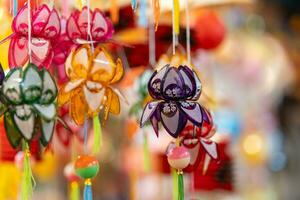 Decorated colorful lanterns hanging on a stand in the streets in Ho Chi Minh City, Vietnam during Mid Autumn Festival. Chinese language in photos mean money and happiness