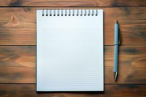 Blank notebook with white sheets and pen on a wooden table. Business concept photo