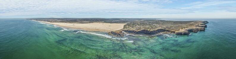 Drone panorama over the surf spot Bordeiras Beach on the Portuguese Atlantic coast during the day photo