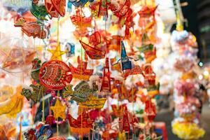 Decorated colorful lanterns hanging on a stand in the streets in Ho Chi Minh City, Vietnam during Mid Autumn Festival. Chinese language in photos mean money and happiness. Selective focus.