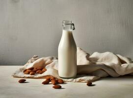 Organic almond milk in glass bottle near ceramic bowl with raw almonds on stone table in the kitchen ready for cooking. Created with Generative AI technology. photo