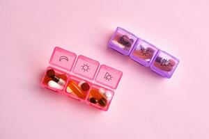 Bright pill box with different pills and vitamins. photo