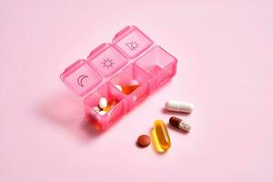 Bright pill box with different pills and vitamins. photo