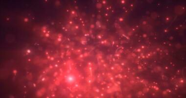 Abstract red energy particles and dots glowing flying sparks festive with bokeh effect and blur background photo