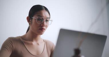 Footage of young adult working and typing on a laptop computer. video