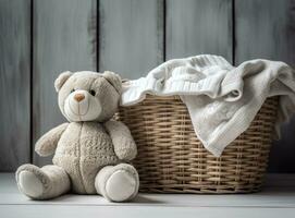 A basket of white laundry, a teddy bunny toy, a bottle of liquid detergent, washing gel or fabric softener. Mockup for washing baby clothes with copy space. Created with Generative AI technology photo
