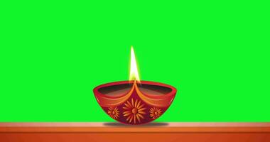 olio lampada ardente nel verde schermo sfondo. Diwali celebrazione, Festival di luci. video