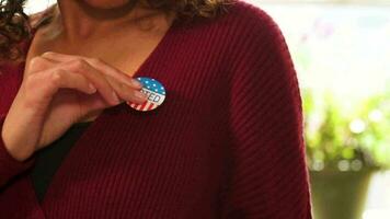 Close Up Hispanic Woman Putting on I Voted Sticker After Voting in the General Election video