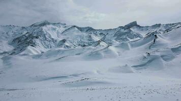 Aerial view drone flying over beautiful white snowy mountains video