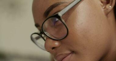 Black student reading data on gadget video