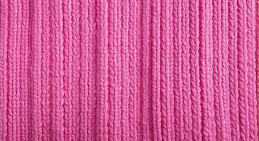 Generative AI, knitted pink sweater texture closeup, magenta or light pink abstract background photo