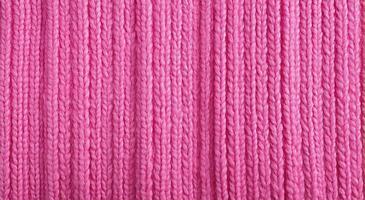 Generative AI, knitted pink sweater texture closeup, magenta or light pink abstract background photo