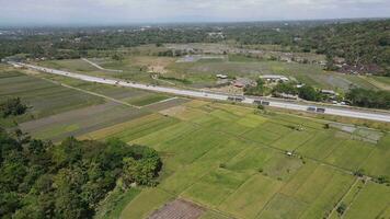 Aerial view of toll road that surrounded by nature in Java , Indonesia video