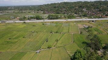 Aerial view of toll road that surrounded by nature in Java , Indonesia video