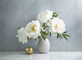 Fresh white peony flowers on light gray table background. Empty place for emotional, sentimental text, quote or sayings. Closeup. photo