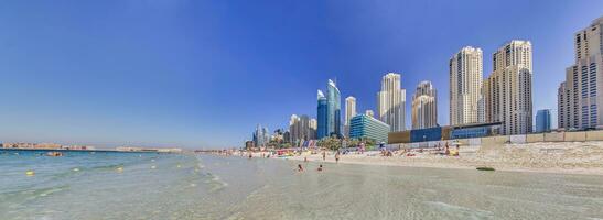 Panoramic view over beach and skyline of Marina district in Dubai photo