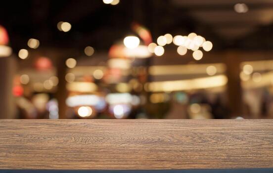 Mock up for space. Empty dark wooden table in front of abstract blurred bokeh background of restaurant . can be used for display or montage your product photo
