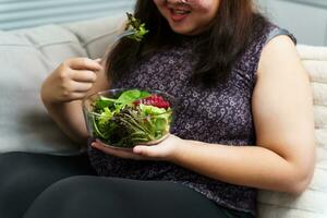 Asian Overweight woman dieting Weight loss eating fresh fresh homemade salad healthy eating concept Obese Woman with weight diet lifestyle. photo