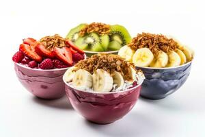 Colorful acai bowls with granola coconut flakes and fruit isolated on a white background photo