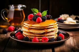 Inviting stack of pancakes adorned with syrup and berries on rustic table photo