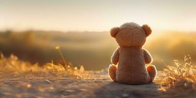 ai generado. ai generativo. solo desaparecido uno juguete muñeca pequeño oso sentado mirando en puesta de sol antecedentes paisaje exterior. gráfico Arte foto