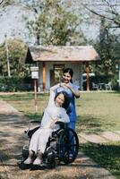 young asian physical therapist working with senior woman on walking with a walker photo