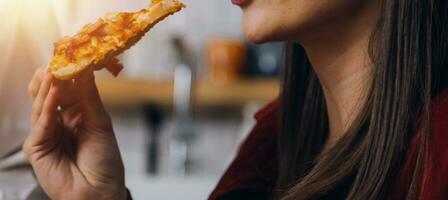 Laughing group of diverse young woman hanging out at home together and eating pizzaLaughing group of diverse young woman hanging out at home  eating pizza photo