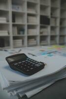 Business accounting concept, Business Man using calculator with computer laptop,pen, budget and loan paper in office. photo