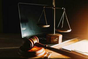 law legal technology concept. judge gavel on computer with scales of justice on desk of lawyer. photo