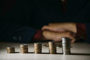 Money, Financial, Business Growth concept, Man's hand put money coins to stack of coins photo