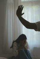 Upset woman having a fight with a man at home. Hispanic wife slapping the face of her husband during an argument because of their relationship problems photo