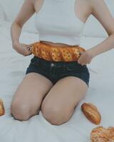 Young attractive girl Spanish appearance delighted with the surprise. And The Morning Started With An Unexpected Healthy Breakfast. In surprise, she waved her hands and rejoices at what is happening. photo