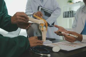 Group of doctors reading a document in meeting room at hospital photo